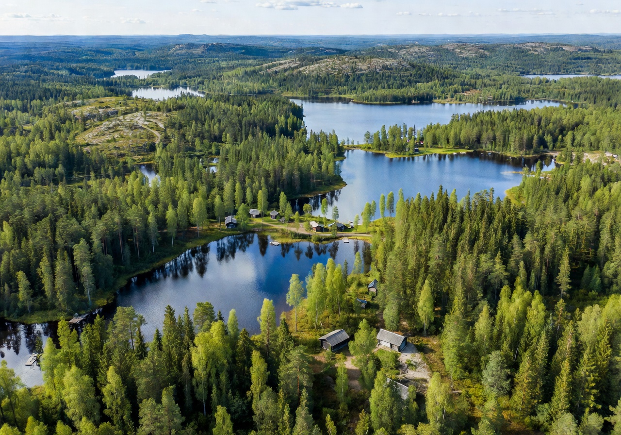 Aerial view of Finnish forest and lakes showing the natural landscape we build in